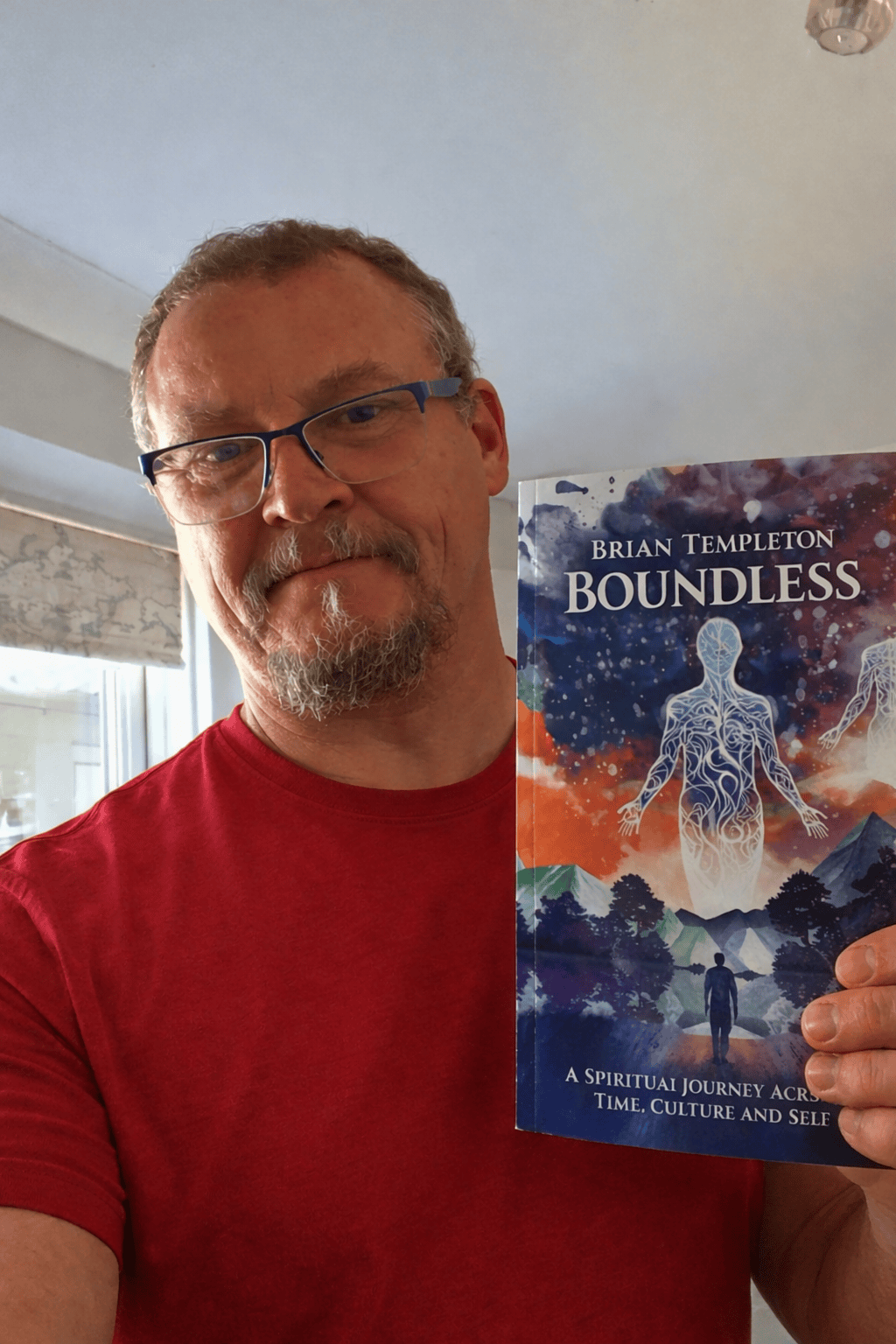 Happy reader holding Brian Templeton's debut novel Boundless